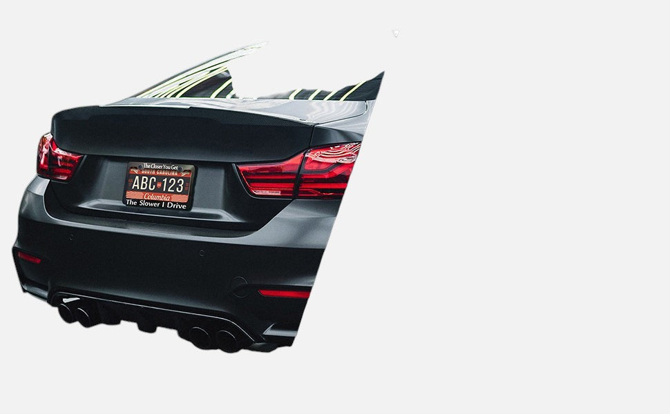 GoPlates custom laser-engraved anodized aluminum license plate frame installed on the rear of a black luxury car.