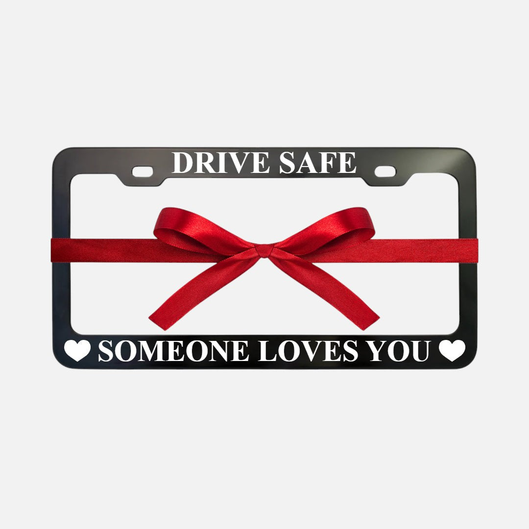 GoPlates black anodized aluminum license plate frame with laser engraved text and a red gift ribbon