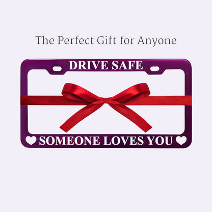 GoPlates custom purple anodized aluminum license plate frame with laser-engraved text and a decorative red gift bow.