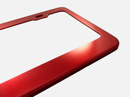 Red anodized aluminum license plate frame finish close-up